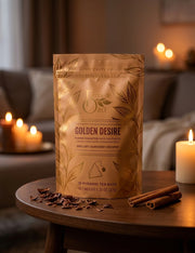 Golden Desire tea package in a warm, candlelit cacao-gold living room scene